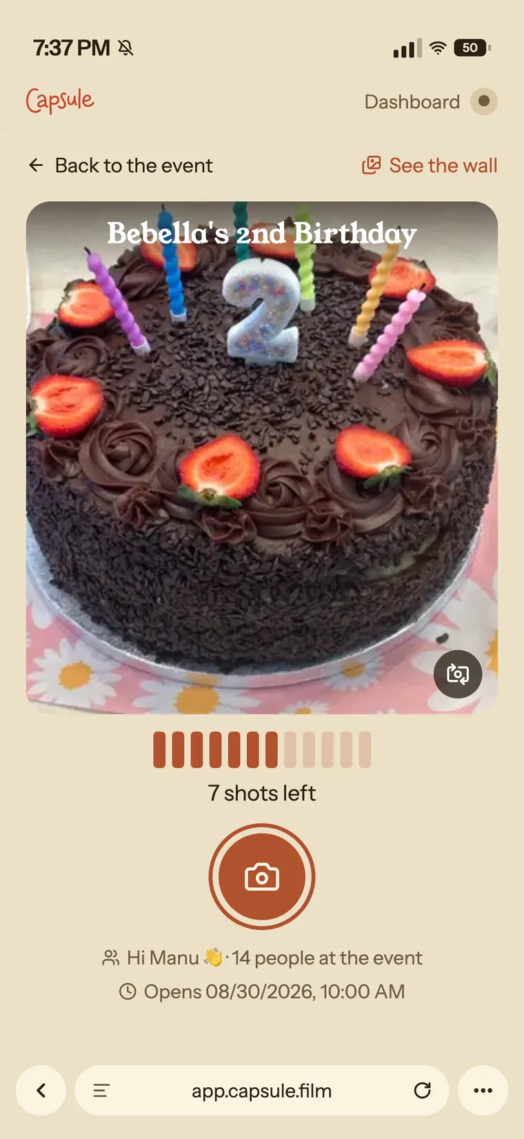 The camera screen on a phone: the viewfinder pointed at a birthday cake, the shots left, the shutter button, and the browser address bar visible underneath