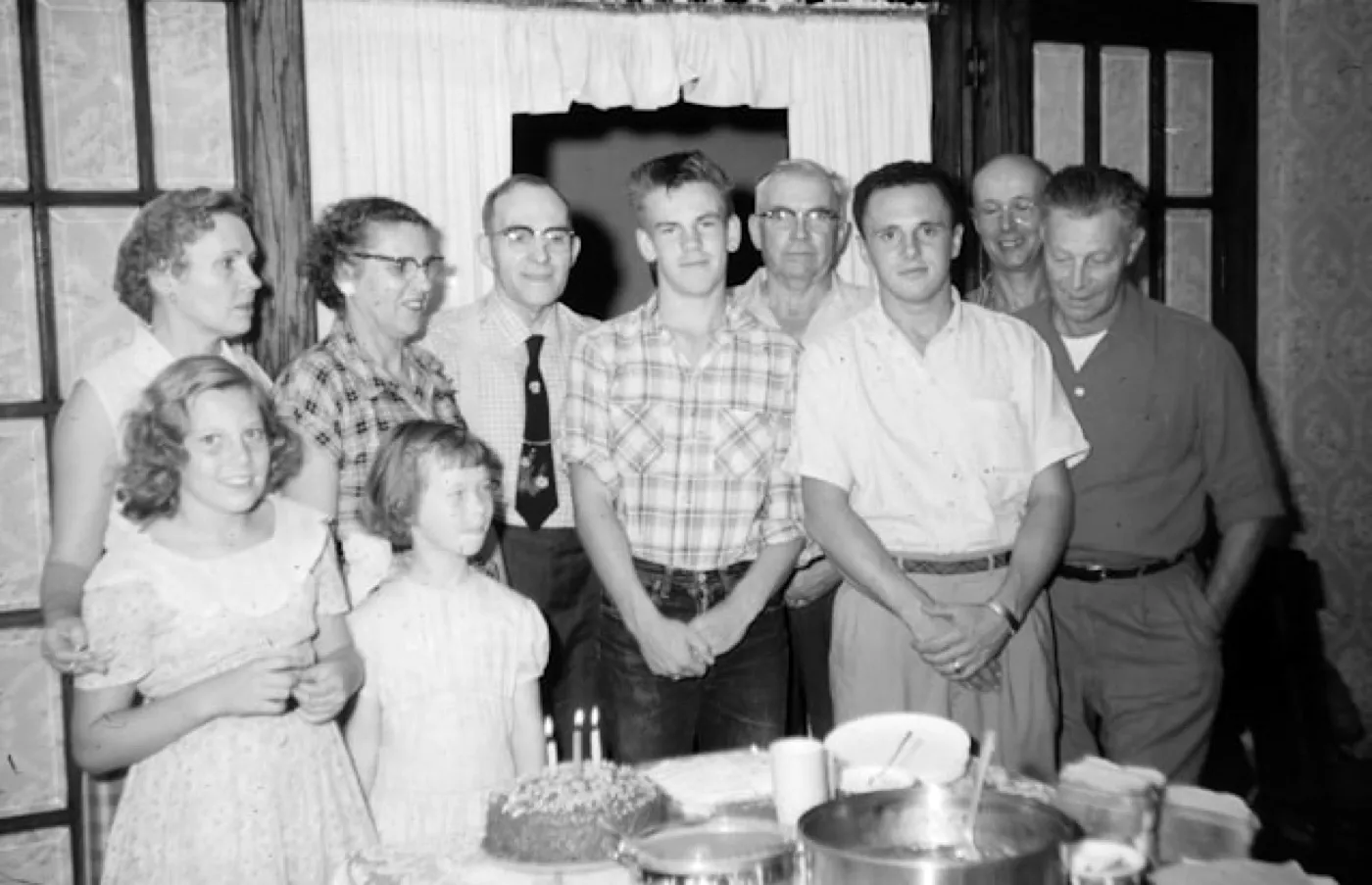 The same family photo around the cake, developed on the Black & White camera: no color, with deep shadows.